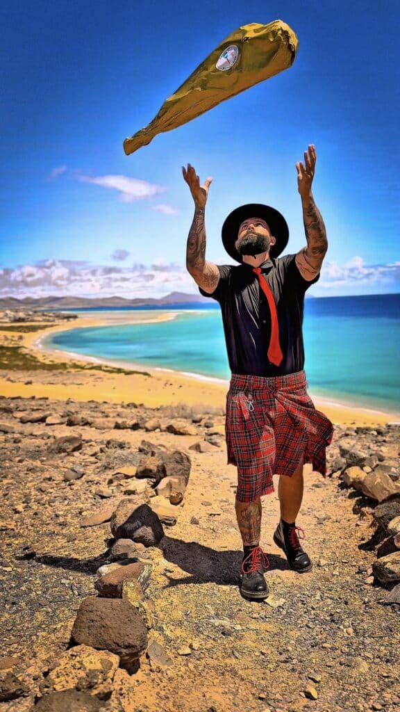 Julio García, cortador profesional de jamón en Fuerteventura, lanzando una pieza de jamón ibérico al aire frente a la costa para Galician Ham Carver.