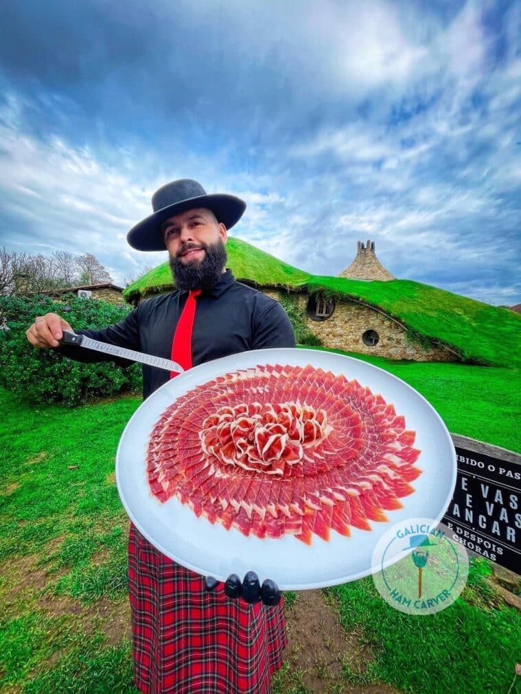 Master carving Iberian ham at an event