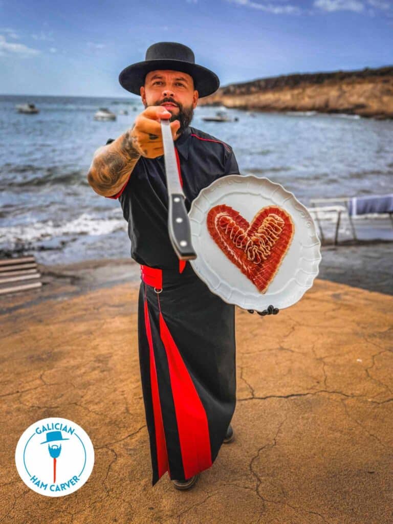 iberian-ham-carving-experience-at-home-tenerife-anniversary Professional ham carver at-home in Tenerife South preparing heart-shaped ham for a romantic dinner in Costa Adeje, Playa de las Américas, and Los Cristianos
